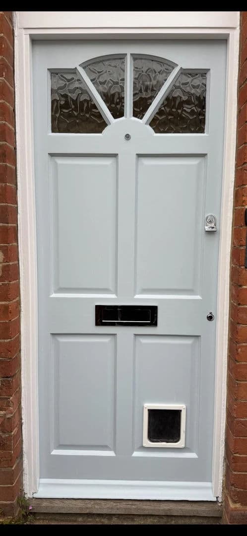 Front door repainted in soft grey – after